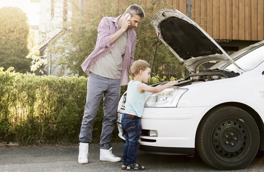 Father and son working on their car